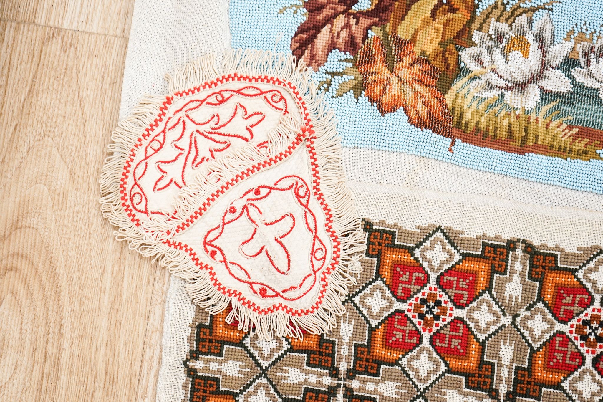 A Berlin beadwork tray panel, an Indian embroidered cloth etc.